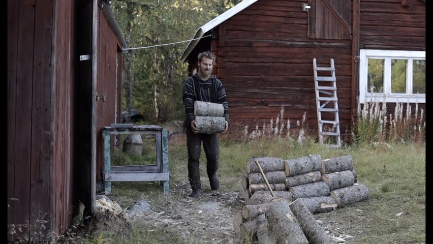 Making fire wood  - log cabin in Sweden, axe and chain saw