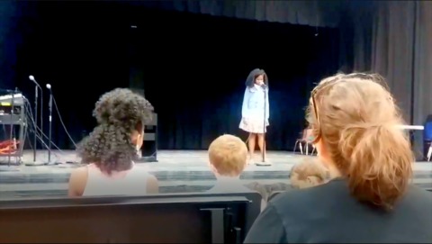 "I'll rise unafraid": Mom leaps into action when daughter freezes on stage