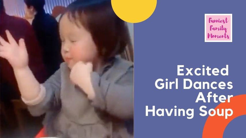 Excited girl dances after having her favourite soup in restaurant in Shanghai