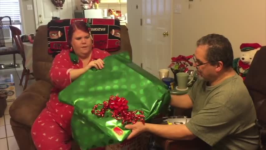 Parents unwrap surprise gift from twin daughters. One look at their gift—dad falls to his knees