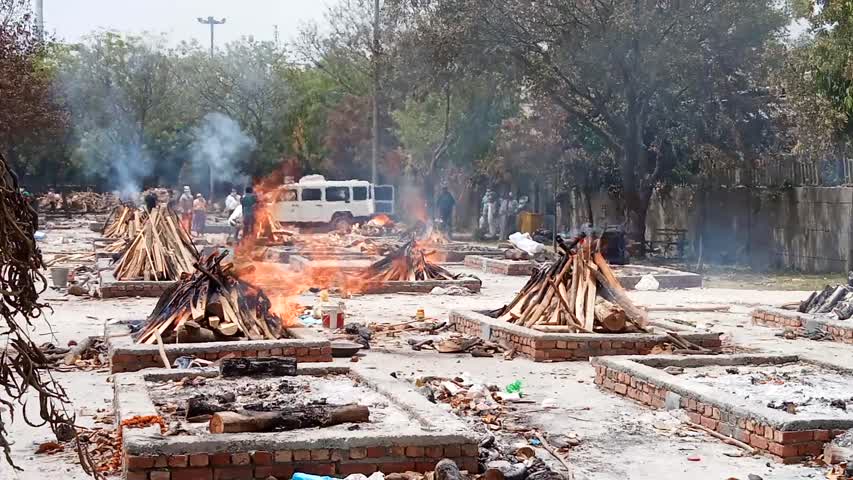 Funeral pyres at a crematorium at Sare Kale Khan outside New Delhi, India