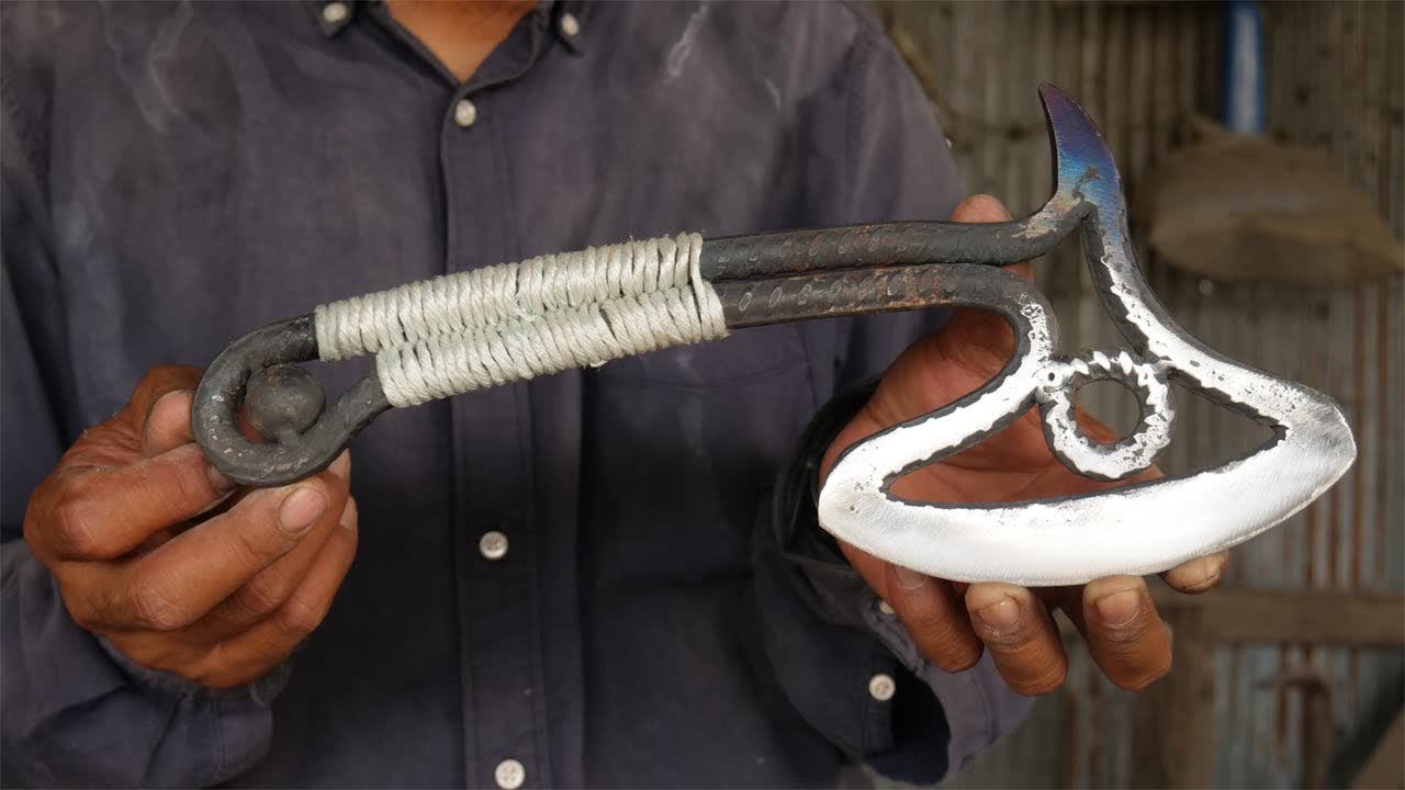 HE MAKES AN AXE FROM A REBAR AND BEARING BALL FOR THE FIRST TIME BUT IT LOOKS VERY EASY FOR HIM