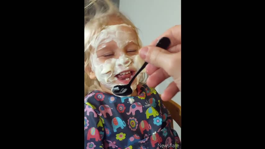 Two-year-old Can't Contain Her Laughter As Dad Paints Her Face in Yoghurt