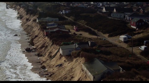 Drone footage from Hemsby showing houses sitting on collapsed cliff edge