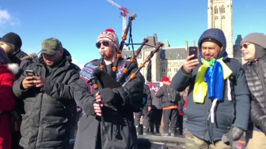 A man performs with bagpipes during the truck convoy protest against COVID-19 mandates and restrictions in Ottawa