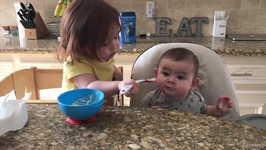 Little Girl Adorably Feeds Baby Brother Spoonfuls of Oatmeal
