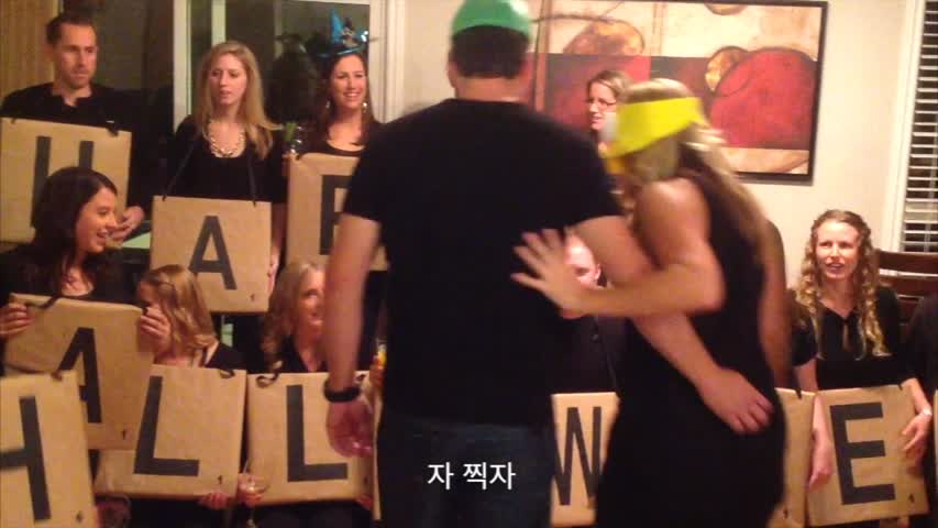 Couple take party group photo at Halloween party—but watch closely how the letters mysteriously change
