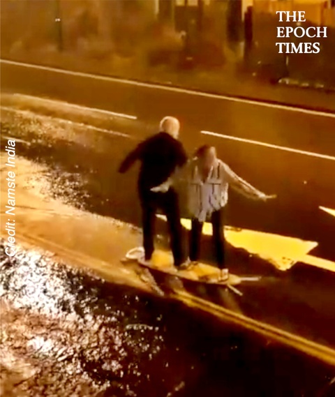 Elderly Couple Go Surfing on Ironing Board in the Rain