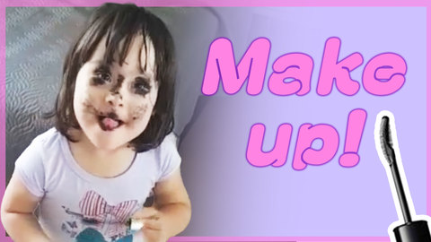 Little Girl Paints Face With Mascara